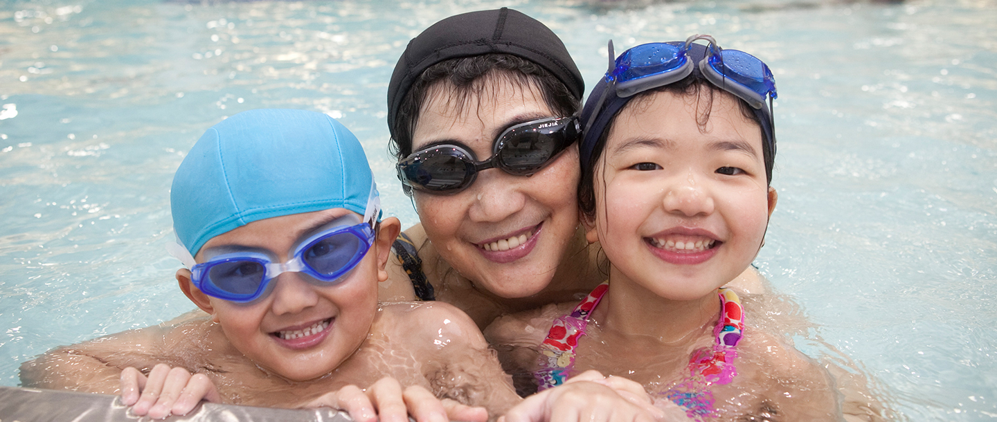 Family swimming together during rec open pool time at the YMCA