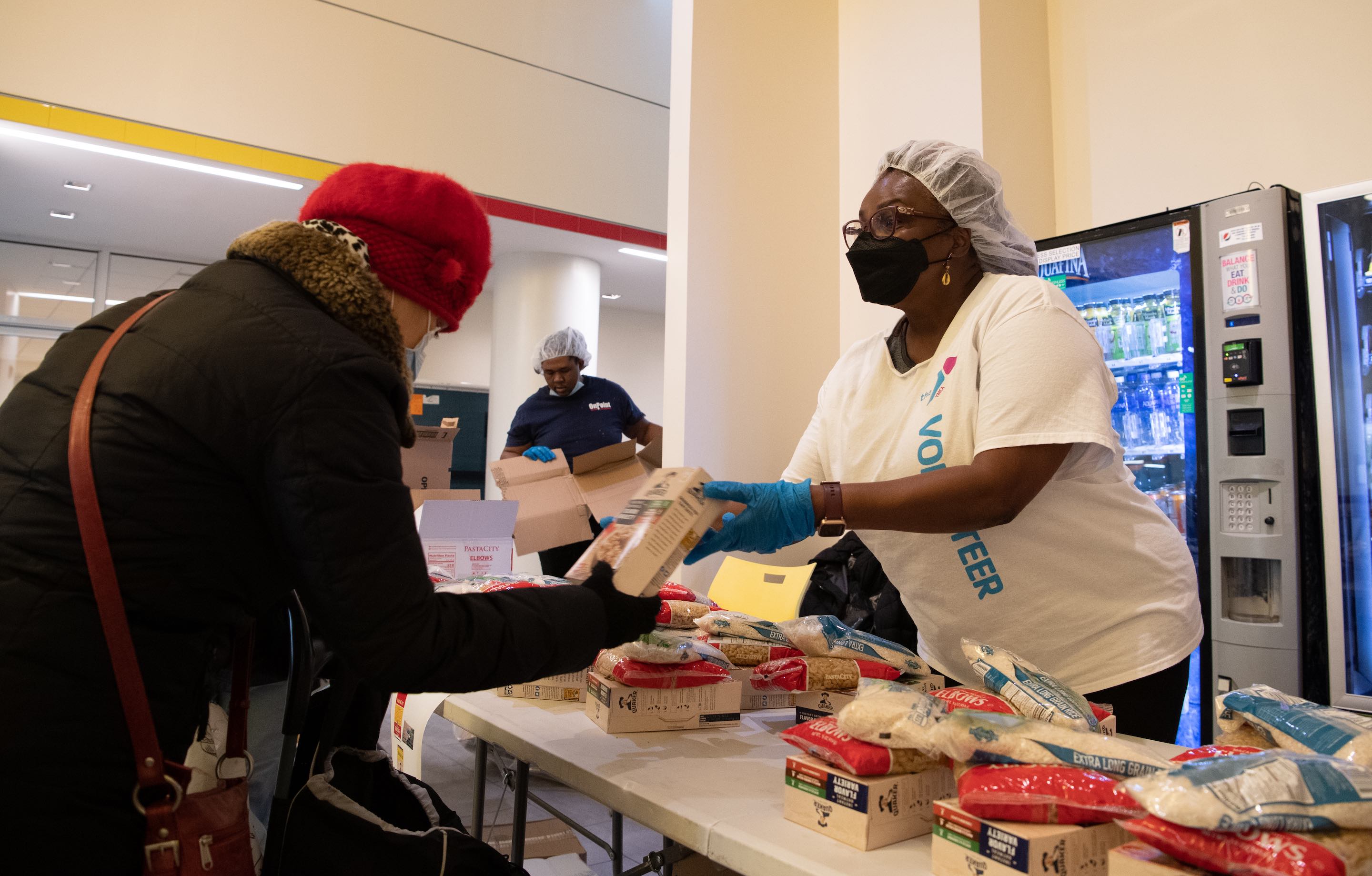 woman distributing food behind a table