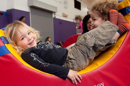 Toddlers playing in indoor YMCA gym