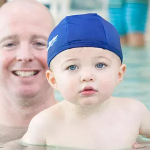 Dad and baby swimming in Rockaway YMCA indoor pool