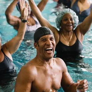 YMCA staff leading water aerobics class at Bronx YMCA indoor pool