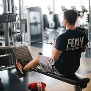 FDNY man using row weight machine at Rockaway YMCA in Queens