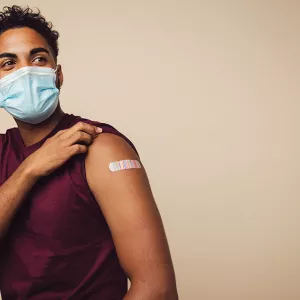 A man wearing a mask posing after getting vaccinated