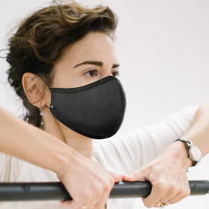 Woman working out with a mask on in a group exercise class