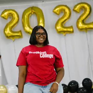 teen in a Brooklyn College t-shirt
