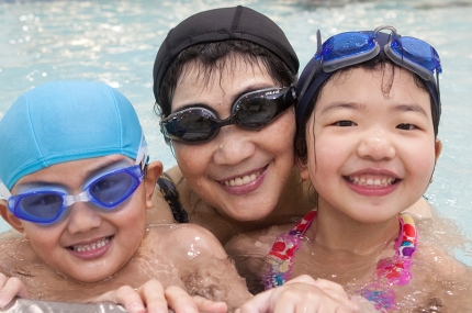 Family swimming in pool at YMCA