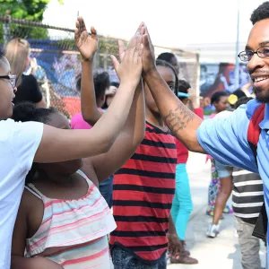 Afterschool staff working with school kids at YMCA program