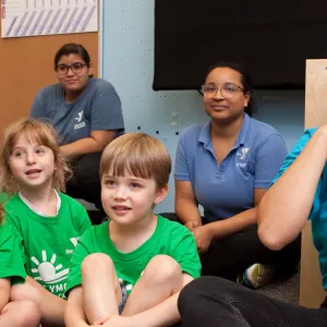 A camp counselor and a group of kids.