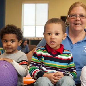 A Y staff member watches kids while their parents work out at the gym.