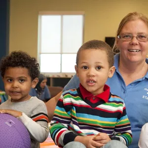 Four children and staff member in child watch room at the YMCA while you work out