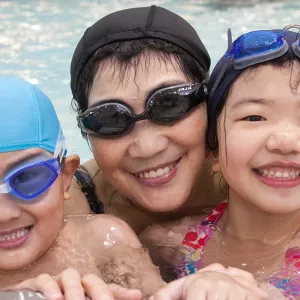 Family swimming together during rec open pool time at the YMCA