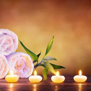 Flowers, towels, and candles for massage therapy