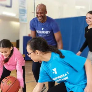 Family playing basketball at the YMCA