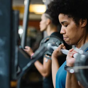 Woman lifting weights at Ridgewood YMCA in Queens