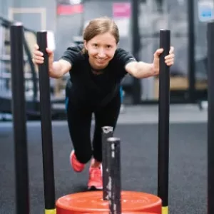 Woman pushing sled