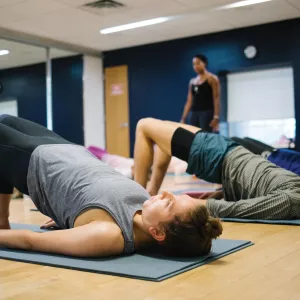 Yoga class doing bridge pose