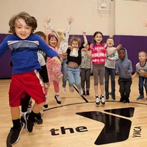 Class of preschoolers jump in YMCA gym